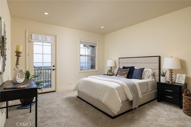 bedroom with multiple windows, access to exterior, and light colored carpet