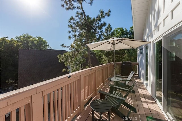 wooden terrace featuring a grill