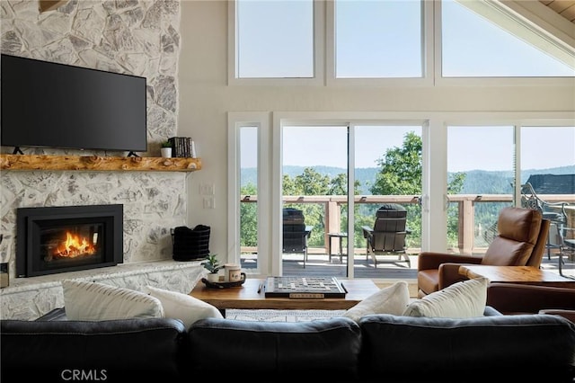 living room with a fireplace and a mountain view