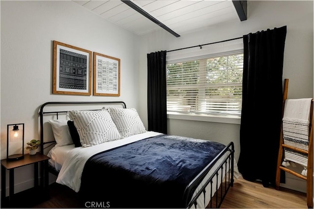bedroom featuring wood ceiling, beam ceiling, and wood-type flooring