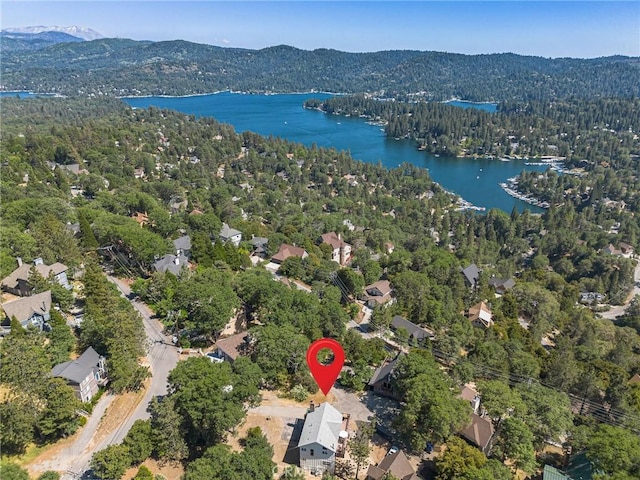 birds eye view of property with a water and mountain view