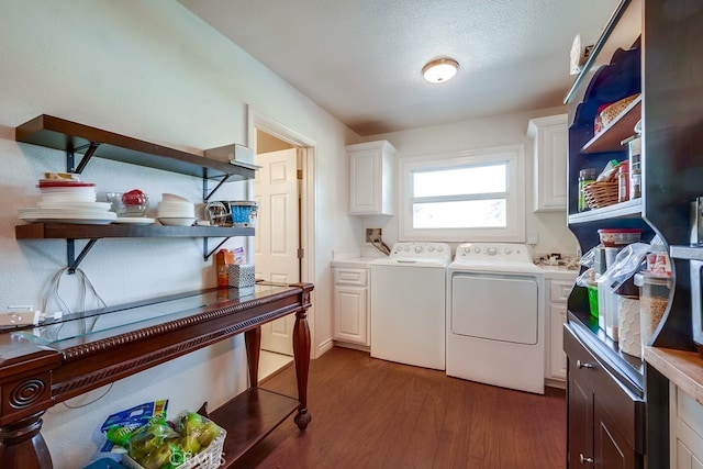 washroom featuring washer and dryer, cabinet space, dark wood finished floors, and a textured ceiling