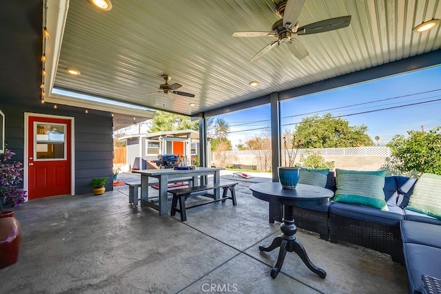 view of patio with ceiling fan, outdoor dining space, an outbuilding, and a fenced backyard