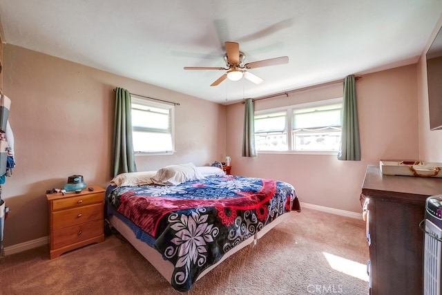 carpeted bedroom with a ceiling fan and baseboards