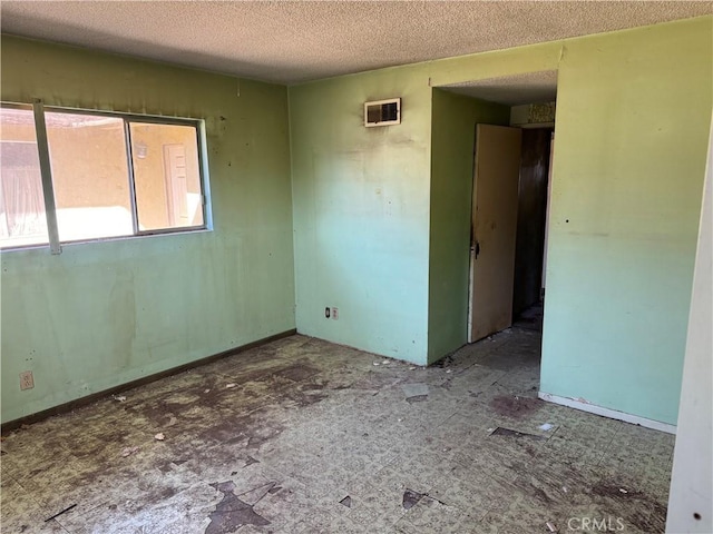 spare room with a textured ceiling