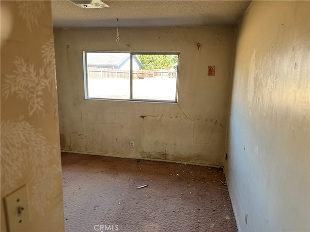 spare room featuring a textured ceiling