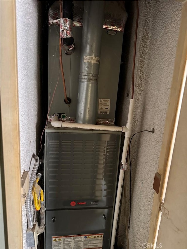 utility room featuring heating unit