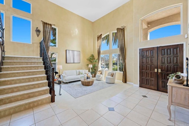 carpeted foyer entrance featuring a high ceiling