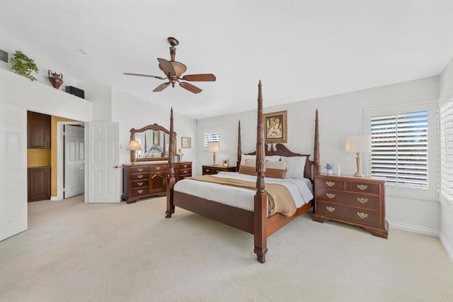 bedroom featuring vaulted ceiling, light carpet, and ceiling fan