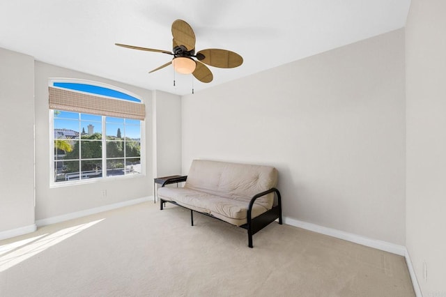 sitting room with light colored carpet and ceiling fan