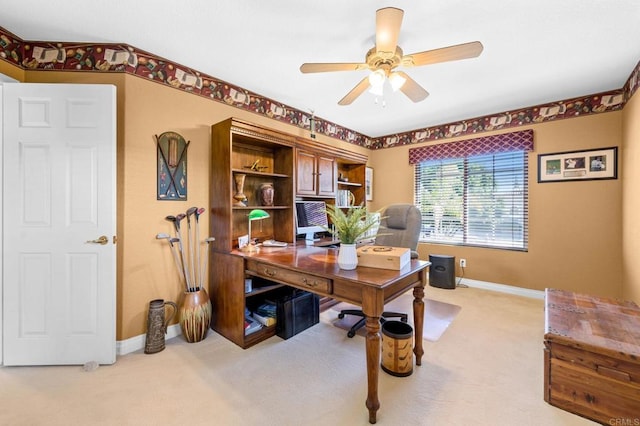 carpeted office space featuring ceiling fan