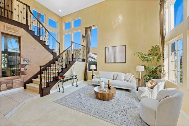 tiled living room with a high ceiling