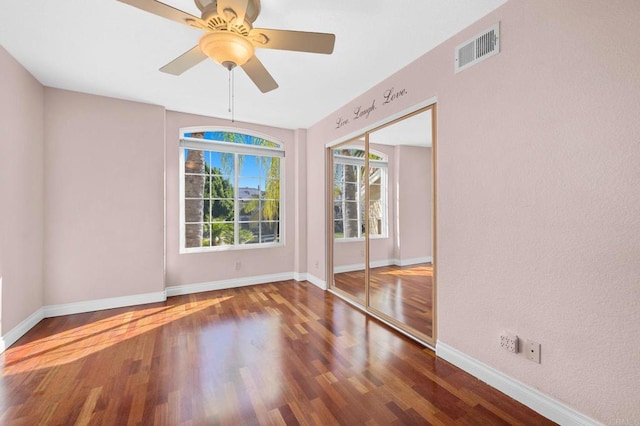 unfurnished room with hardwood / wood-style flooring and ceiling fan