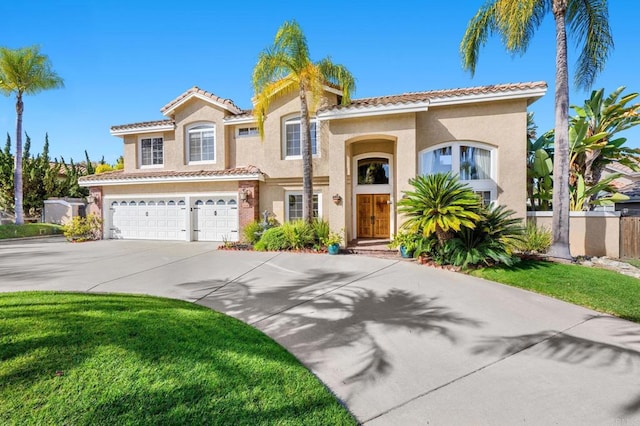 mediterranean / spanish home with a garage and a front yard