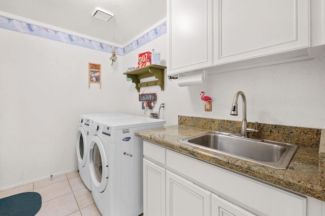 laundry area featuring cabinets, separate washer and dryer, sink, and light tile patterned floors