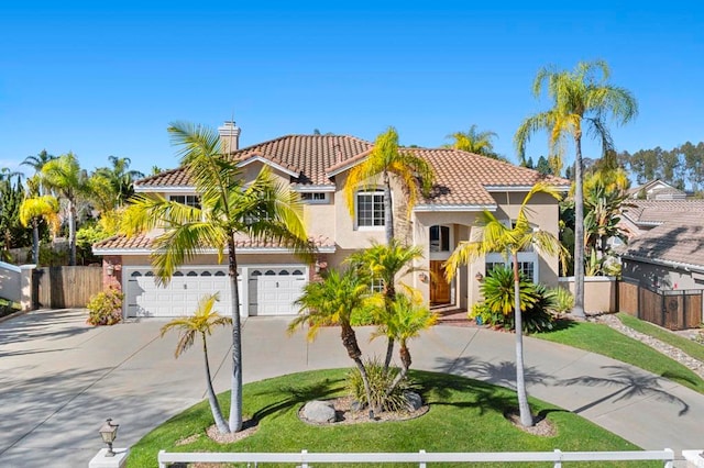 mediterranean / spanish-style house featuring a garage and a front yard