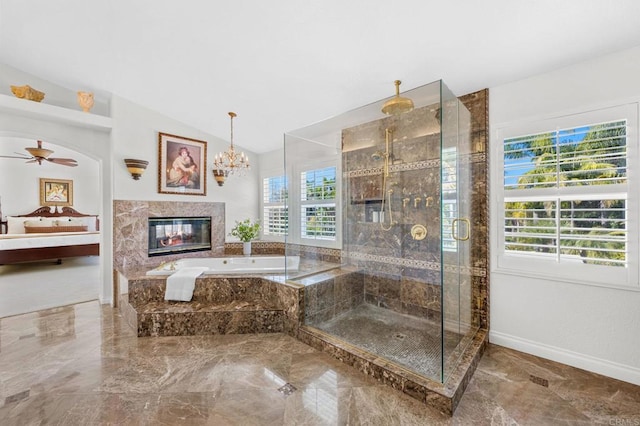 bathroom with vaulted ceiling, plus walk in shower, plenty of natural light, and a fireplace