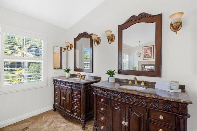 bathroom with vanity, lofted ceiling, and a chandelier