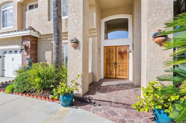 view of exterior entry with a garage