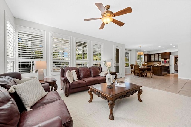 tiled living room with ceiling fan