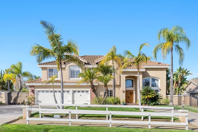 mediterranean / spanish house with a garage