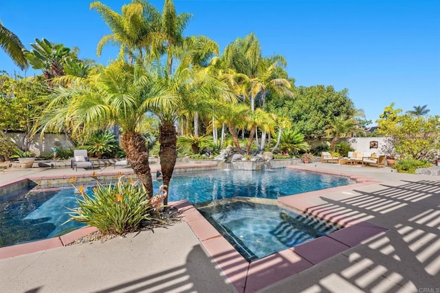 view of swimming pool featuring an in ground hot tub and a patio area