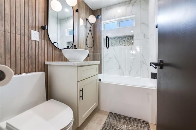 5058 Rose Ave, Riverside, CA 92505 - bathroom with toilet, tile patterned flooring, wooden walls, vanity, and shower / washtub combination