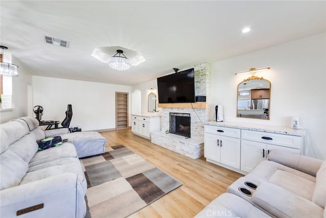 5058 Rose Ave, Riverside, CA 92505 - living room featuring recessed lighting, an inviting chandelier, visible vents, light wood-style floors, and a fireplace