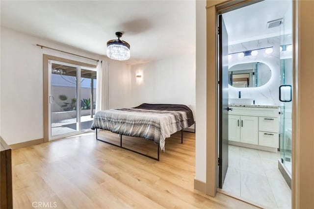 5058 Rose Ave, Riverside, CA 92505 - bedroom with ensuite bathroom, light wood-type flooring, visible vents, an inviting chandelier, and access to exterior