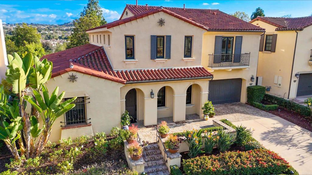 mediterranean / spanish house featuring decorative driveway, a tiled roof, and stucco siding