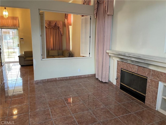 unfurnished living room with dark tile patterned floors and a premium fireplace