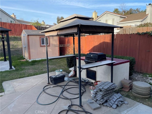 view of patio with a gazebo and a storage unit