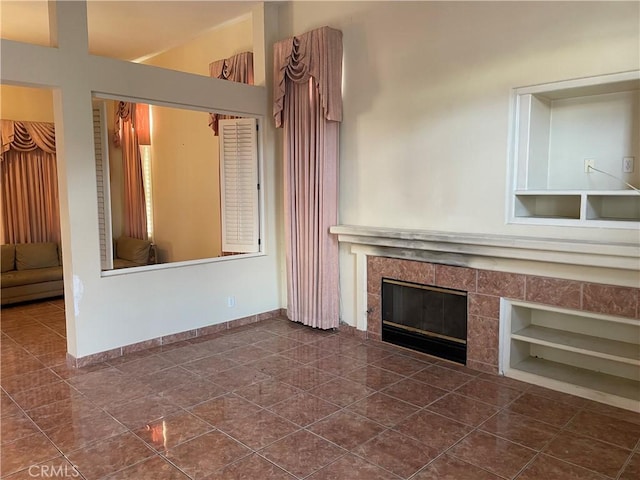 unfurnished living room featuring a fireplace and built in features