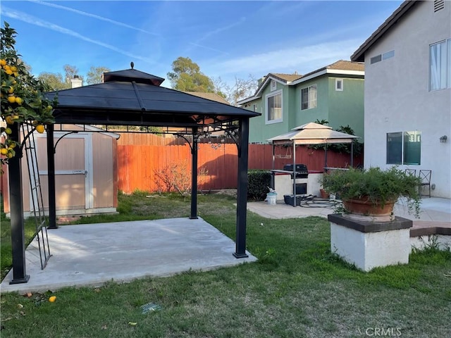 view of patio featuring a gazebo, grilling area, and a shed