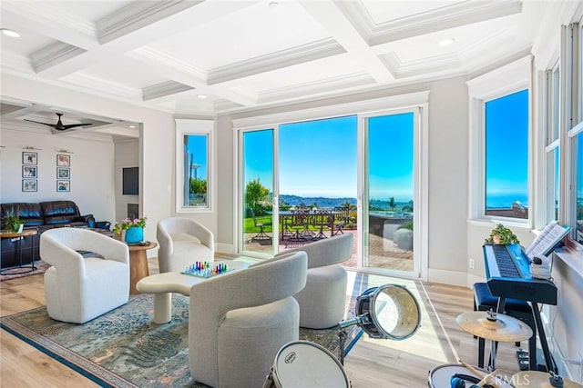 sunroom / solarium with ceiling fan, coffered ceiling, and beam ceiling