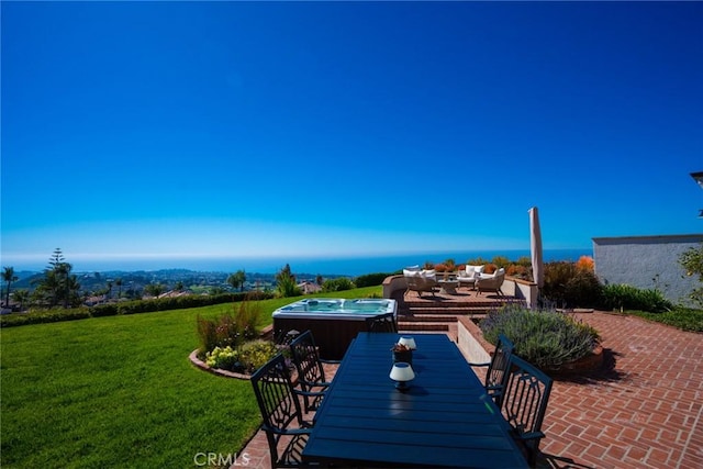 view of patio featuring outdoor dining area and an outdoor hot tub