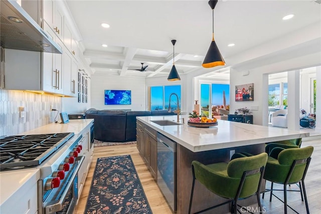 kitchen with a kitchen island with sink, appliances with stainless steel finishes, and white cabinets