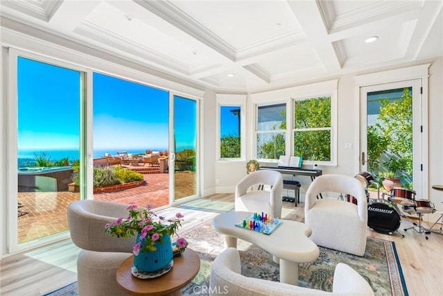 sunroom / solarium featuring beam ceiling, coffered ceiling, and a water view