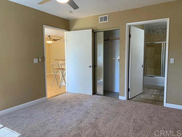 unfurnished bedroom featuring carpet, ceiling fan, and a closet