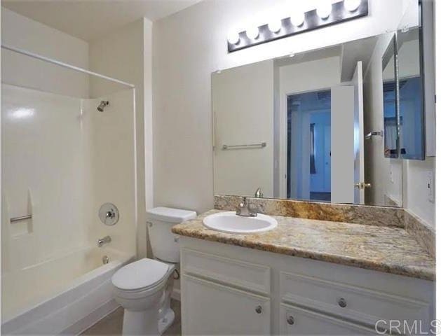 full bathroom with shower / washtub combination, vanity, and toilet