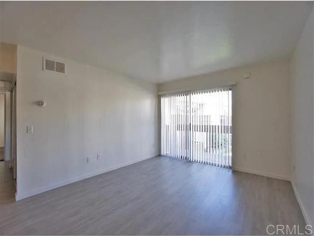 spare room with hardwood / wood-style flooring