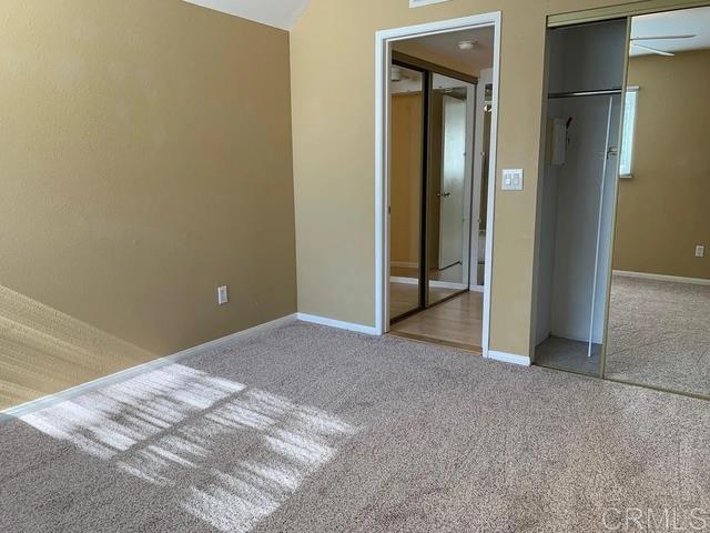 unfurnished bedroom featuring carpet floors and a closet