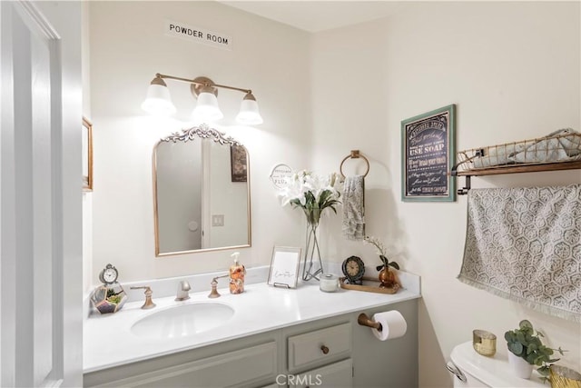 bathroom featuring toilet and vanity