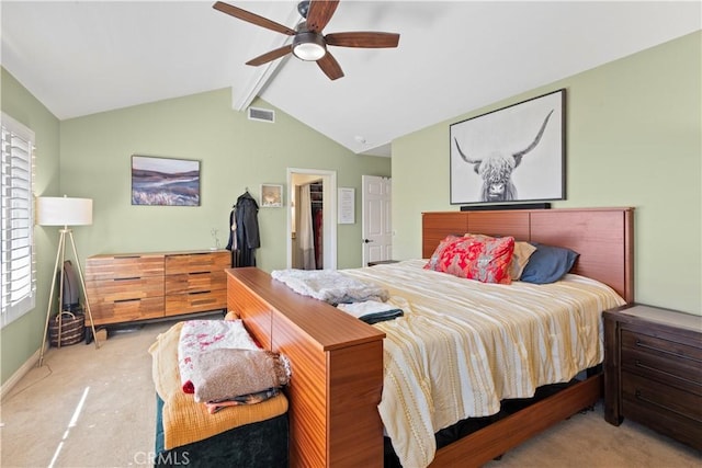 bedroom with vaulted ceiling with beams, carpet, a spacious closet, and visible vents