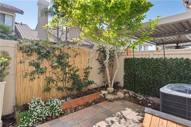 view of patio featuring central AC and a fenced backyard