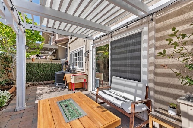 wooden terrace featuring a pergola and a patio