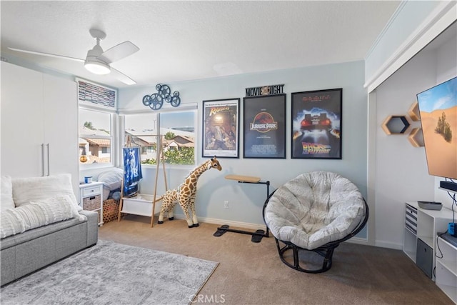 interior space featuring carpet, baseboards, and a ceiling fan