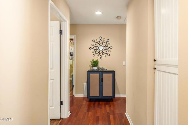 corridor featuring dark wood-style floors, recessed lighting, and baseboards