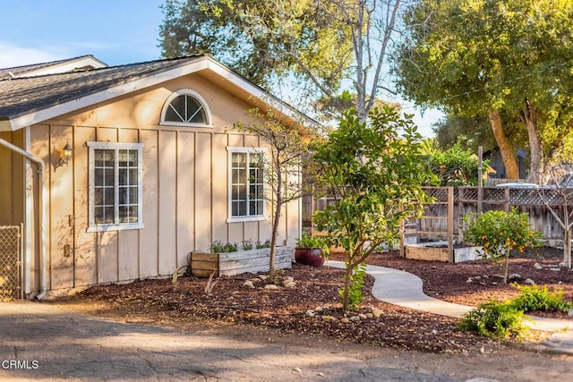 exterior space featuring fence and a garden