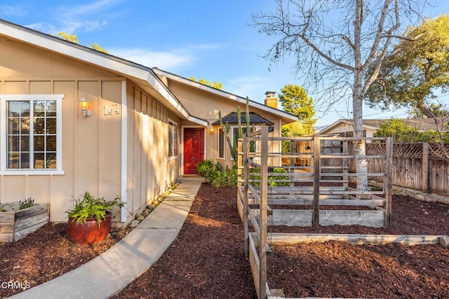 exterior space with a vegetable garden and fence